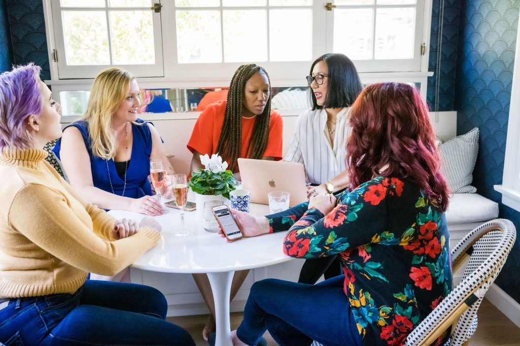 Group of female entrepreneurs talking about how to make more money in their businesses