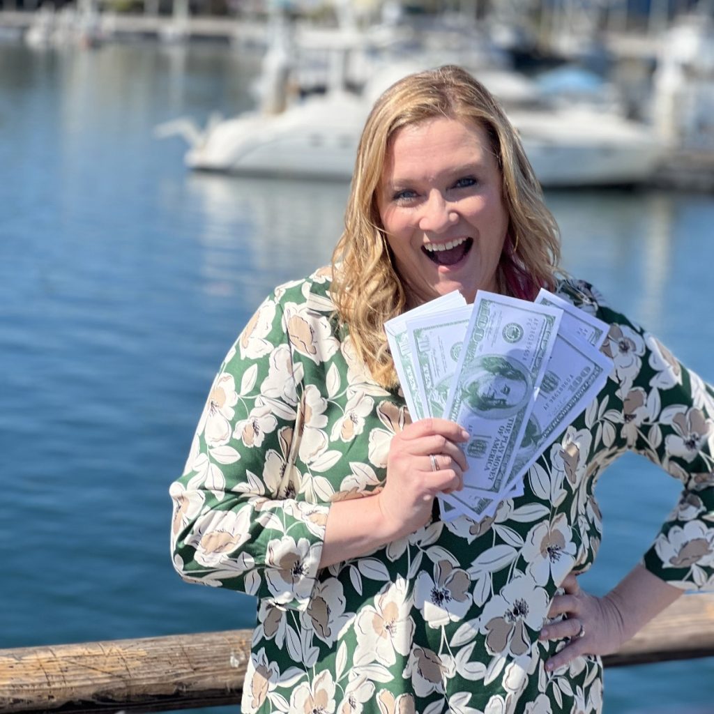 BRA Founder, Carrie Murray, holding cash and smiling