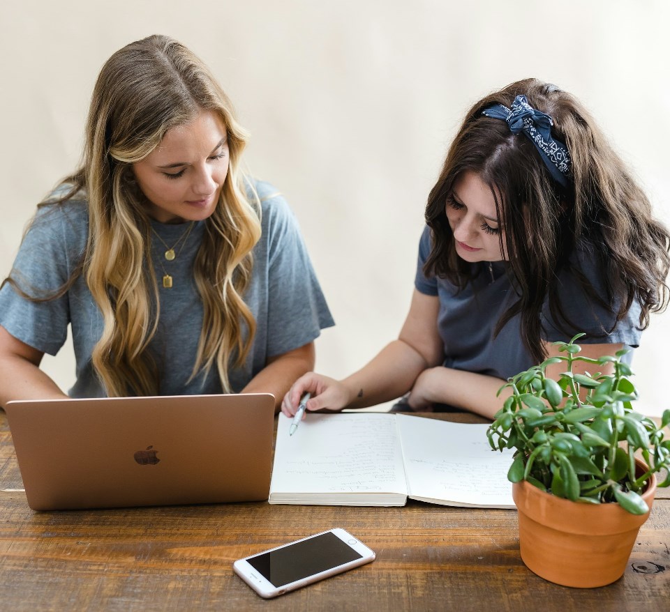 Two women co-founders working on their business finances together